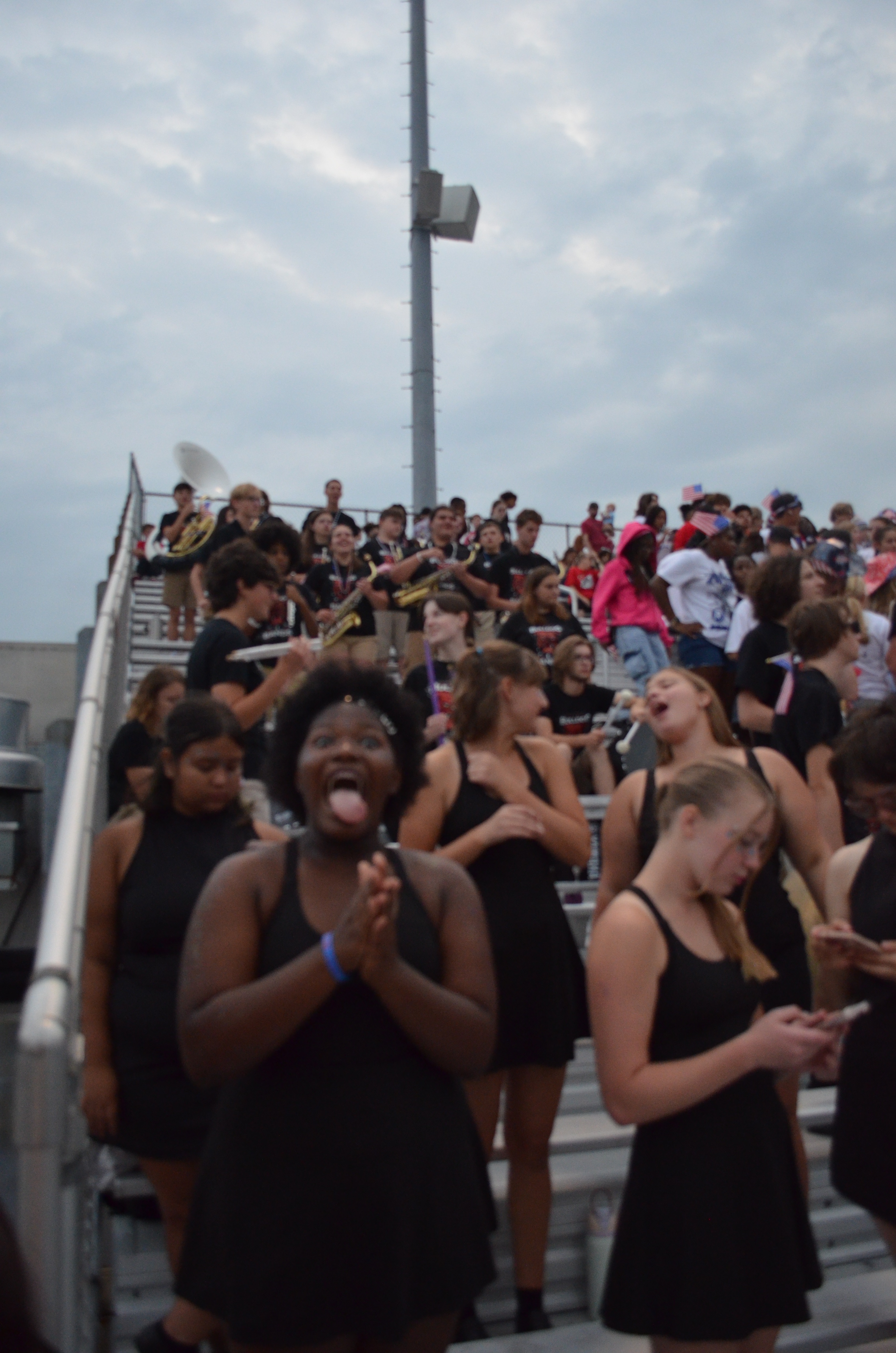 Enthusiastic New Albany students cheering in the stands during football game