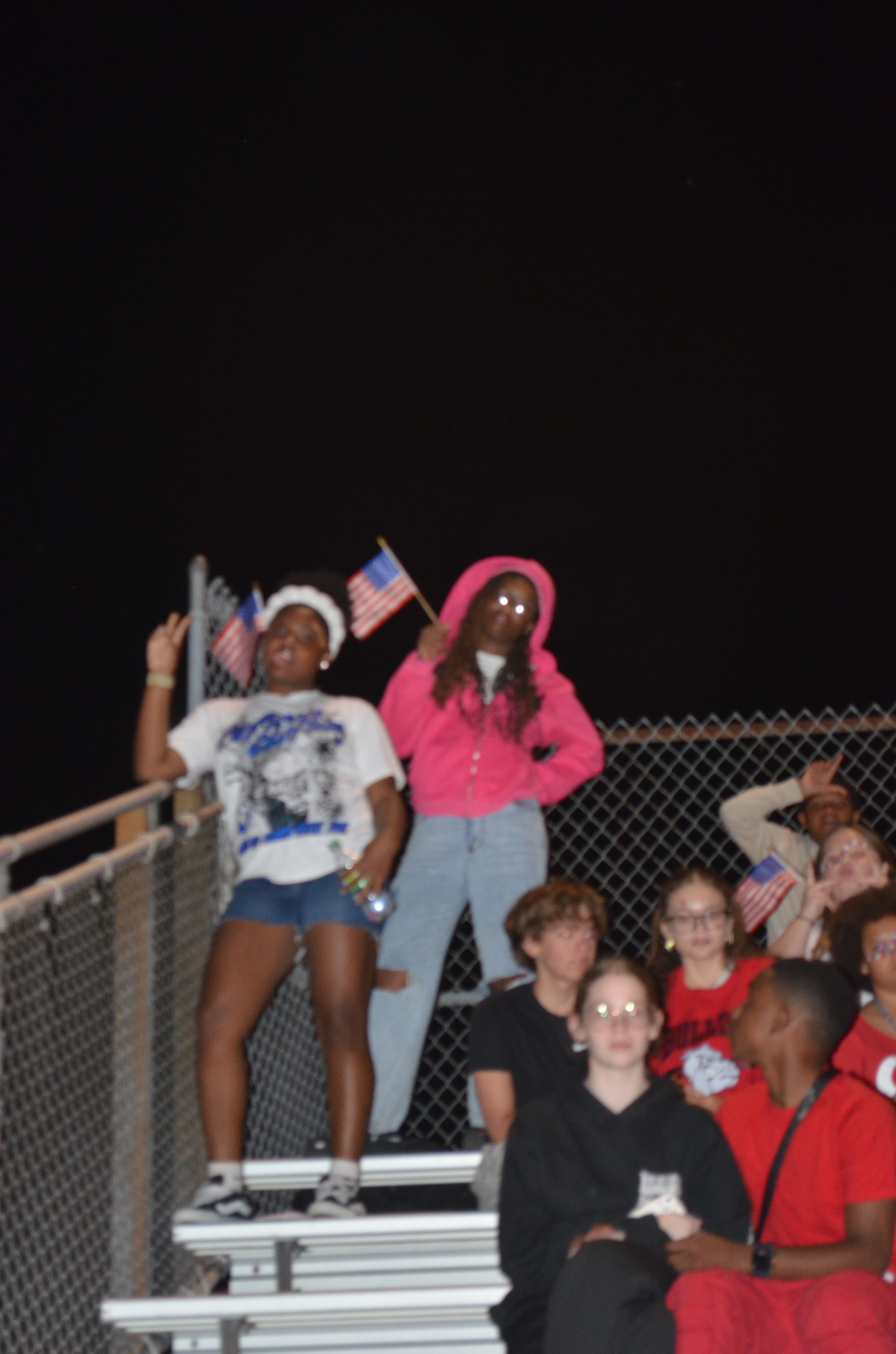 New Albany students displaying American flags and school pride at football game